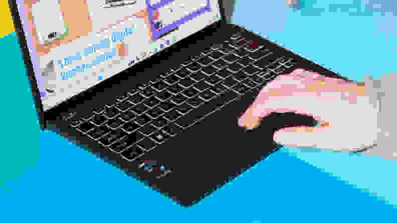 A hand touching the trackpad.