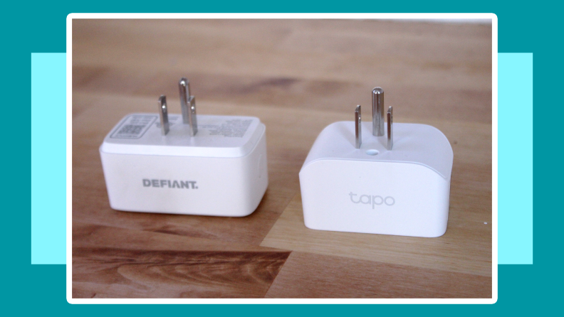 Rectangular Defiant smart plug (on left) next to rounded Tapo smart plug on top of wooden surface.
