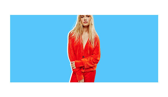 A model wearing a red cardigan.