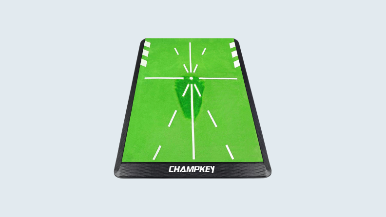 A Champkey golf mat on a gray background.