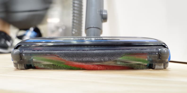 The brush head can swing up when pressed against vertical surfaces.