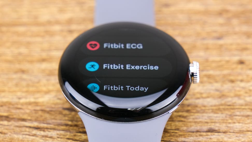 A Google Pixel Watch with its Fitbit menu showing on its display
