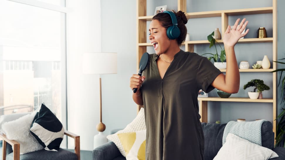 Woman singing into a hairbrush