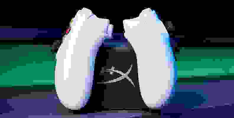 Two game controllers sitting on a charging dock