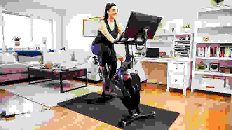woman using peloton bike