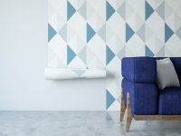Geometric wallpaper pasted on wall with a blue couch in front of the wall.