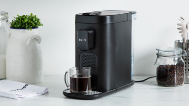 Product shot of the Instant Dual Pod Plus Coffee Maker on granite countertop in kitchen.
