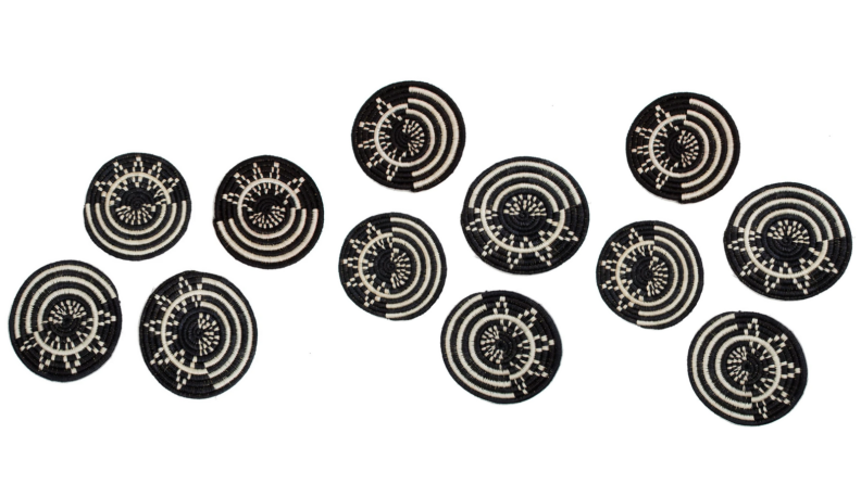 Several black and white, patterned, fabric coasters.