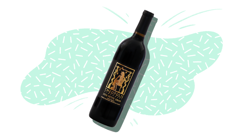 A silhouetted bottle of red wine wine on a mint and white patterned background.