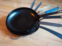 A stack of the best carbon steel pans Reviewed tested from Mauviel, BK Cookware, Blanc Creative, Matfer Bourgeat, De Buyer Mineral B, and more.