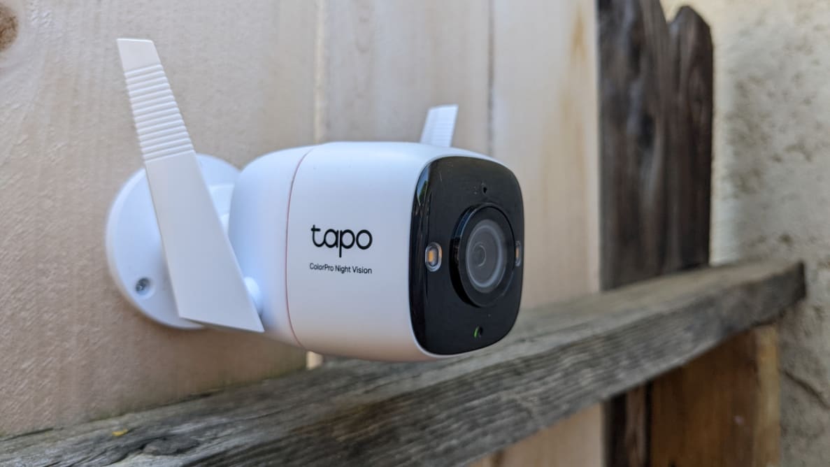 The Tapo C325WB on a wooden fence.