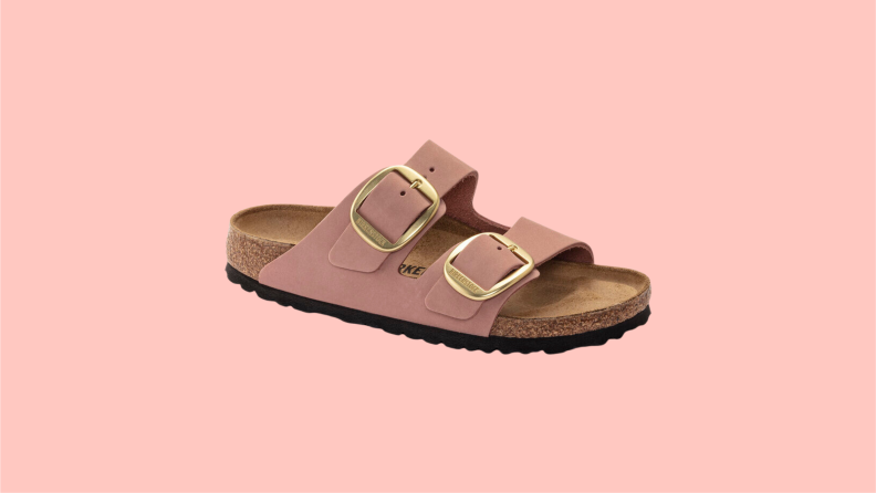 A Birkenstocks leather sandals with two nude pink straps and gold buckles.