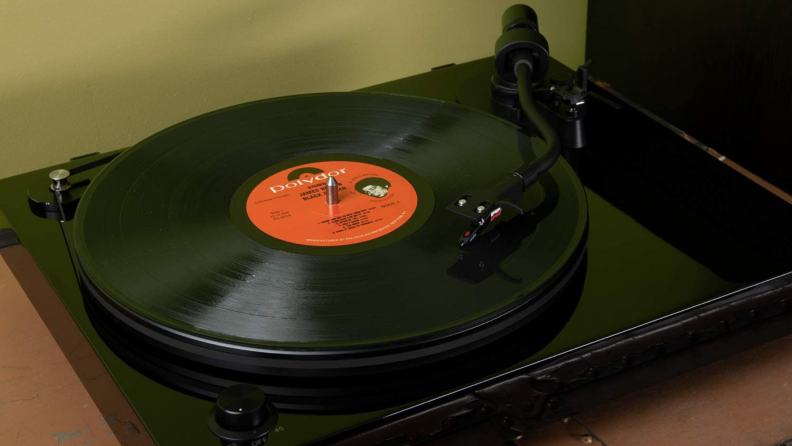 The Fluance RT82 Reference High Fidelity Vinyl Turntable sits on a table.