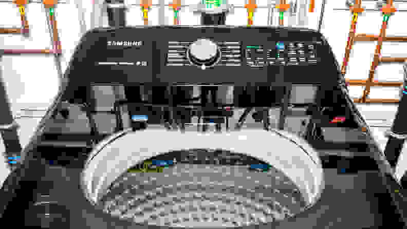 A shot of the top lid of the Samsung WA50R5400AV top-loading washing machine. In the background you can see the elaborate network of pipes we use to regulate water temperature and flow.