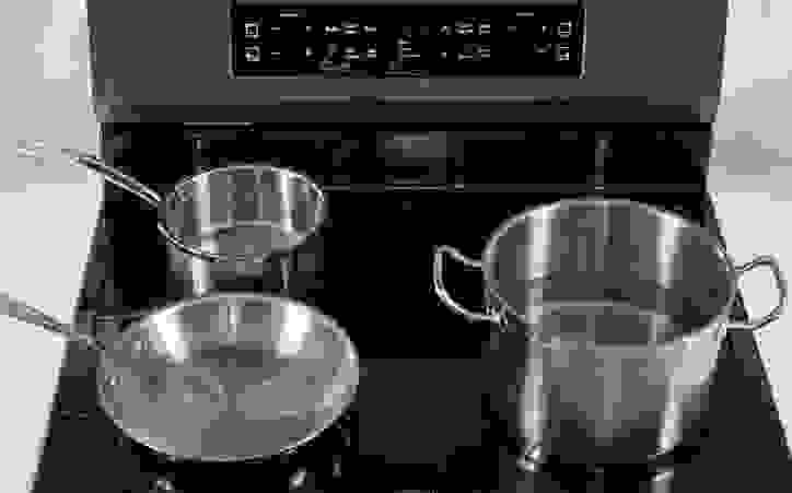 An induction range requires iron or steel pots and pans. You can test your existing pans with magnets. If a magnet sticks, the cookware will work on an induction range.