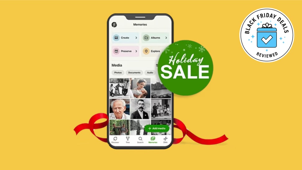 A phone with the AncestryDNA app and a holiday badge on a yellow background.