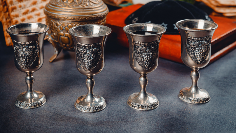 Four silver Passover wine glasses.