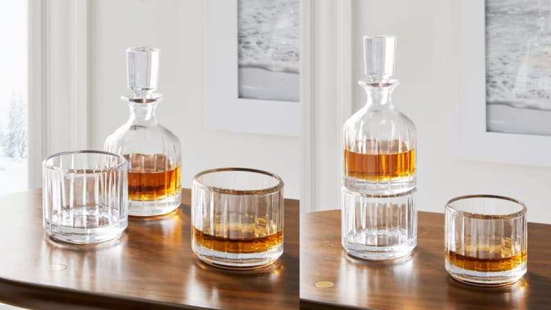 Two whiskey glasses next to decanter on wooden table