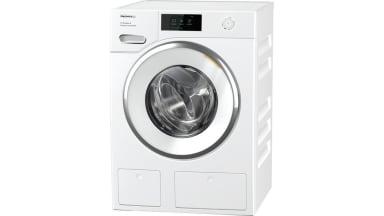 The Miele W1 compact washer sits in a white space.