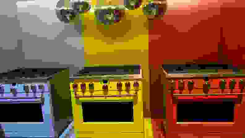 Three Cafe appliances side by side in blue, yellow, and red