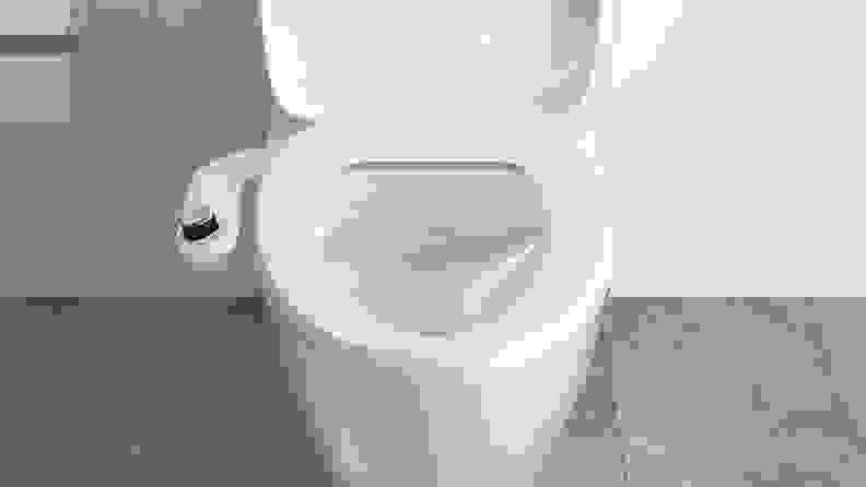 close up of a toilet with a bidet.