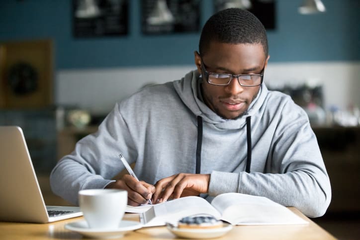 Student studying with books and computre