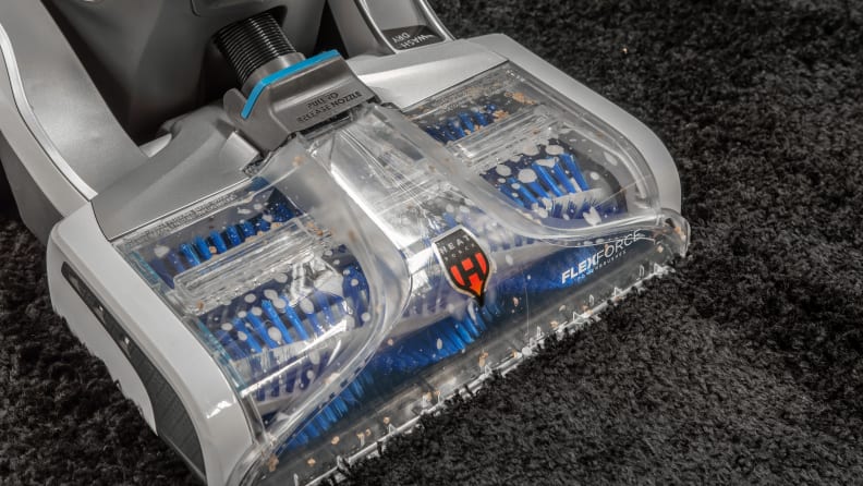 Carpet cleaner cleaning shag throw rug.