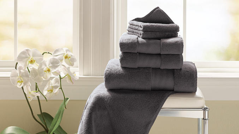 A stack of towels sitting on a stool.