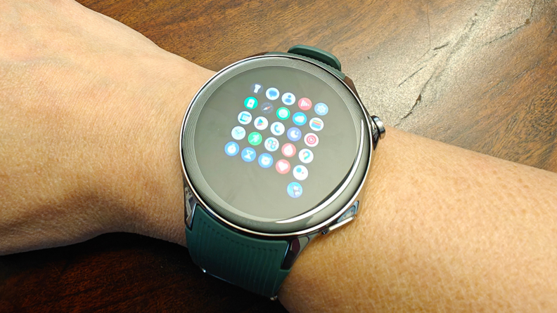 The OnePlus Watch 2 on a wrist with a grid of apps on display.
