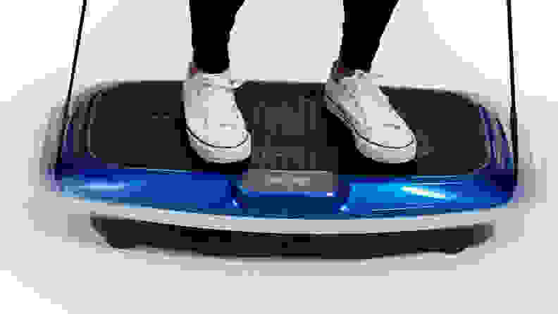 Person wearing a white pair of converse sneakers while the Lifepro Hovert 3D Vibration Plate is in motion.