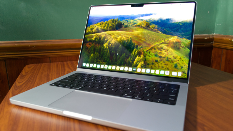 The MacBook Pro 14 M3 with a landscape background on the screen.