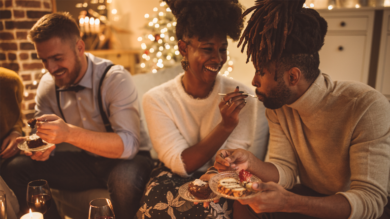 Three party goers enjoy a meal