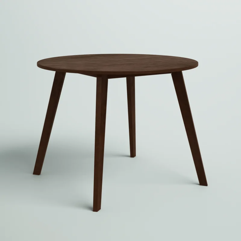 A brown Aquin Round Dining Table on a gray background.