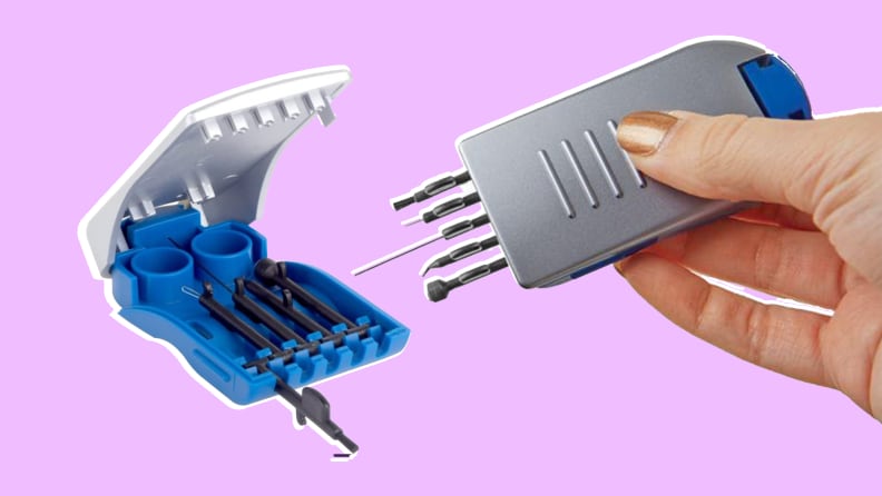 Person holding Ezy Dose 5 in 1 hearing aid cleaning tool kit.