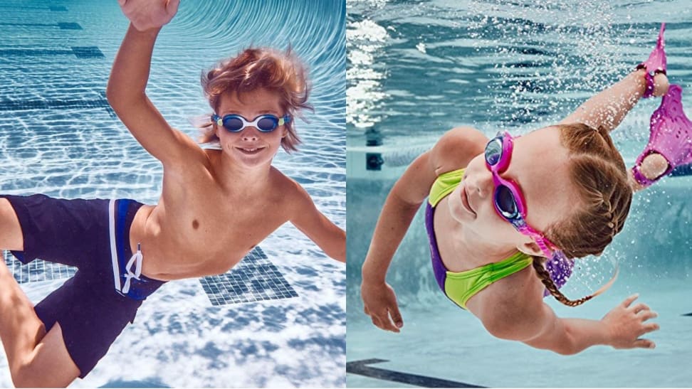 Two kids play in the water while wearing their swimming goggles