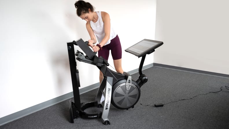 woman folding nordictrack RW 900 rowing machine.