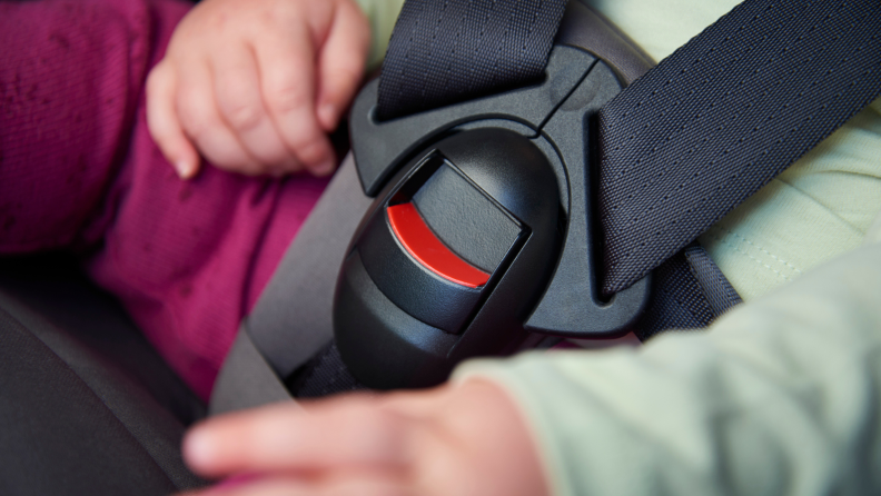 Close up of childs safety buckle on car seat