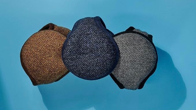 A set of earmuffs on a blue background.