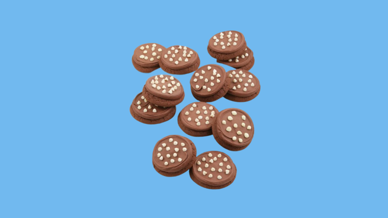 Chocolate, cream-coated cookies against blue background