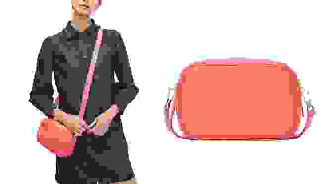 Woman carrying coral colored crossbody