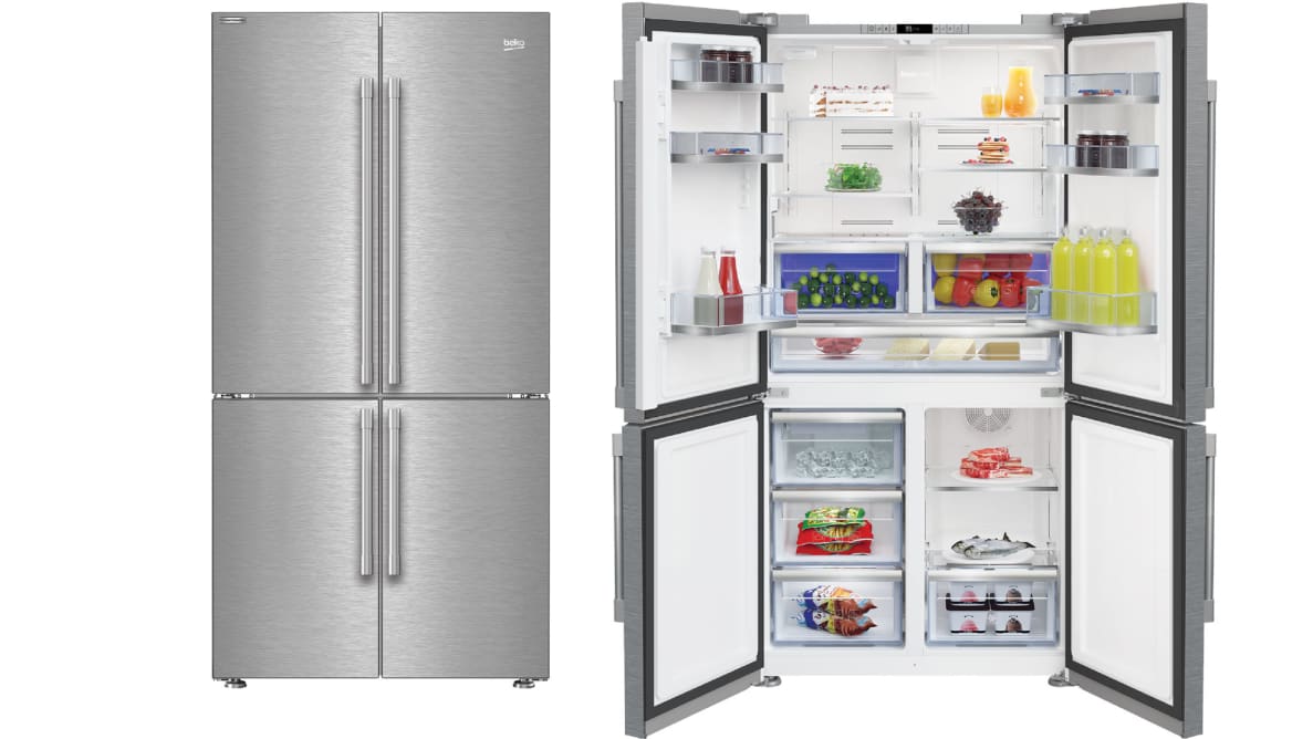 Two of the Beko fridges stand side by side in a white void. The leftmost one has its four doors closed. The rightmost instance has its doors open, and all its shelves and bins are fully stocked with items.