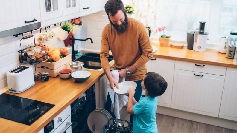 Father and son loading the dishwasher