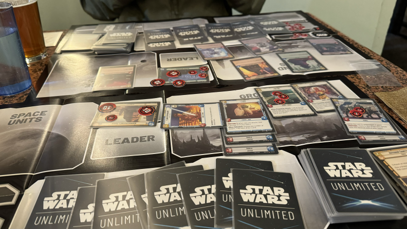 The middle of a game of Star Wars: Unlimited, with cards spread across two playmats.