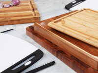 Stacks of wooden and plastic cutting boards on a marble surface