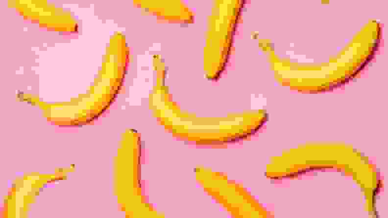 Bananas arranged in a pattern on a pink surface.