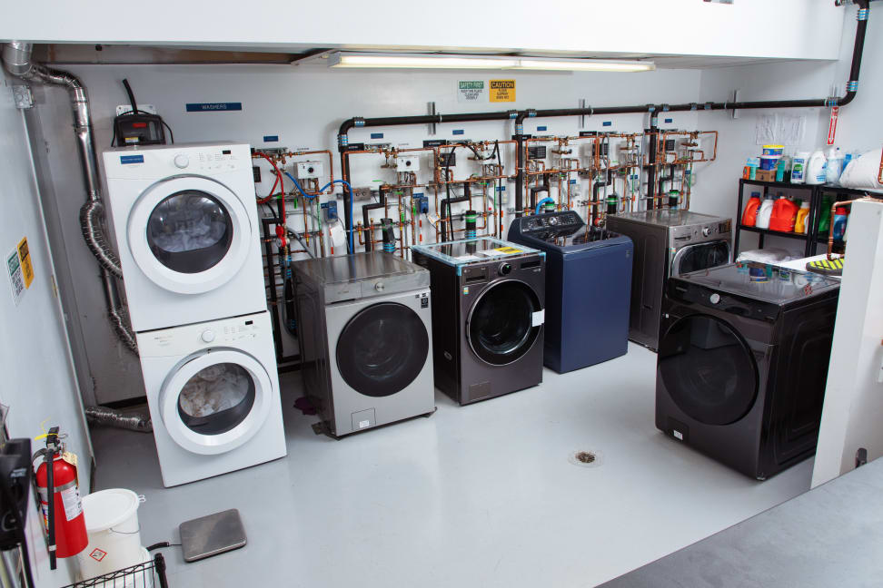 Several washer machines stacked on top of each other indoors.