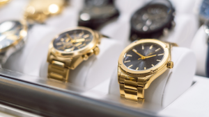 Gold watches in a display case.