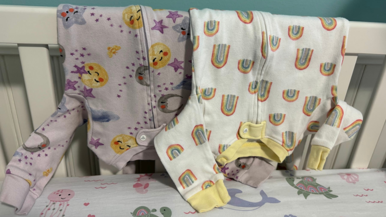 Burt's Bees Baby onesies with rainbows and suns with smiley faces on them.