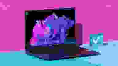 An open laptop against a pink and blue background