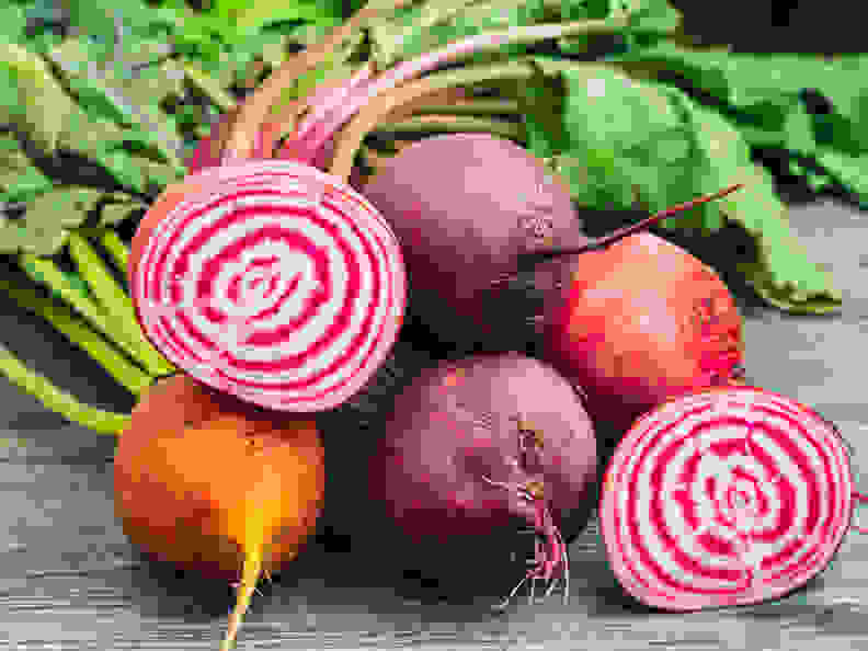 Bunch of fresh organic beet roots on a wooden table.